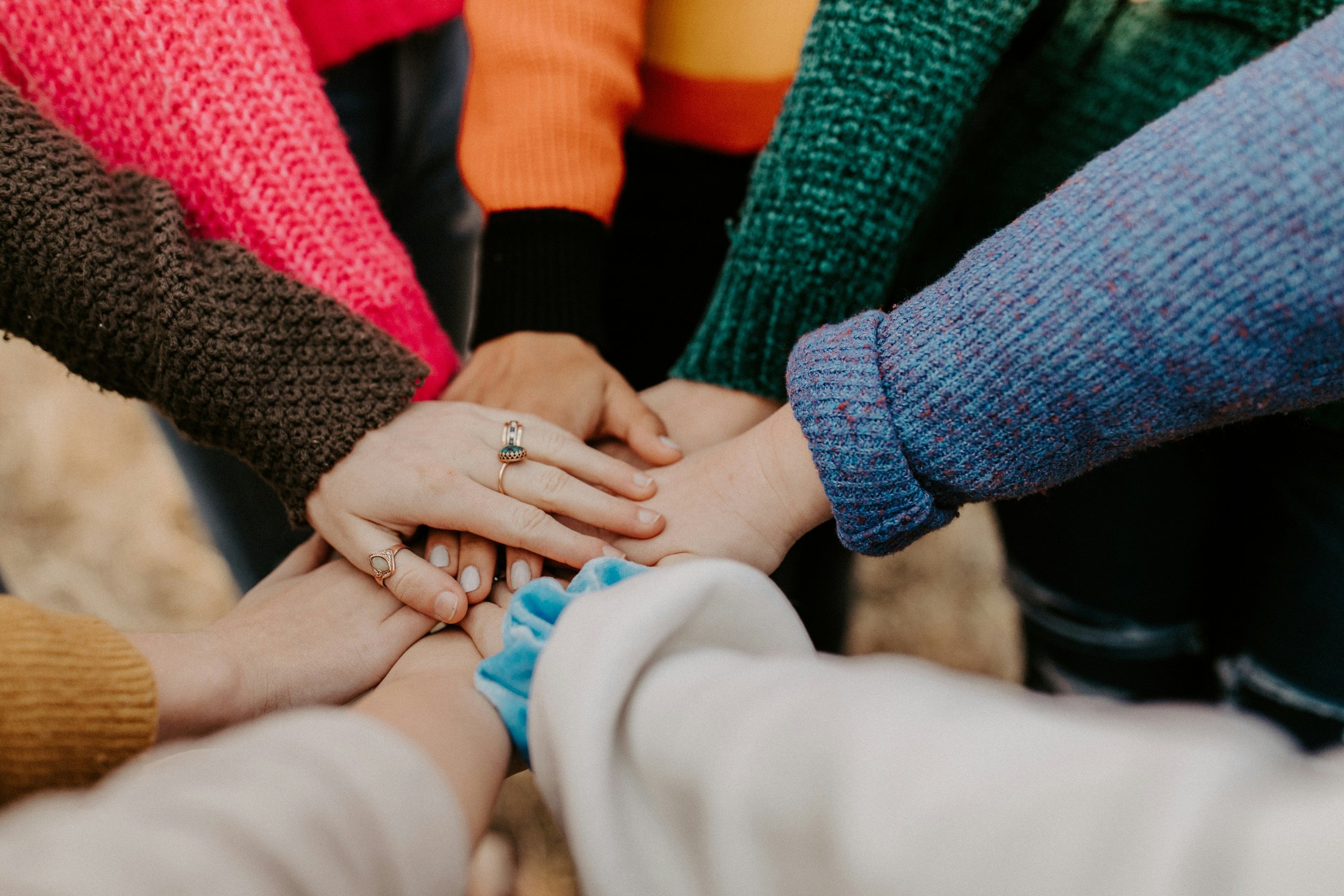 Hands stacked together in a circle