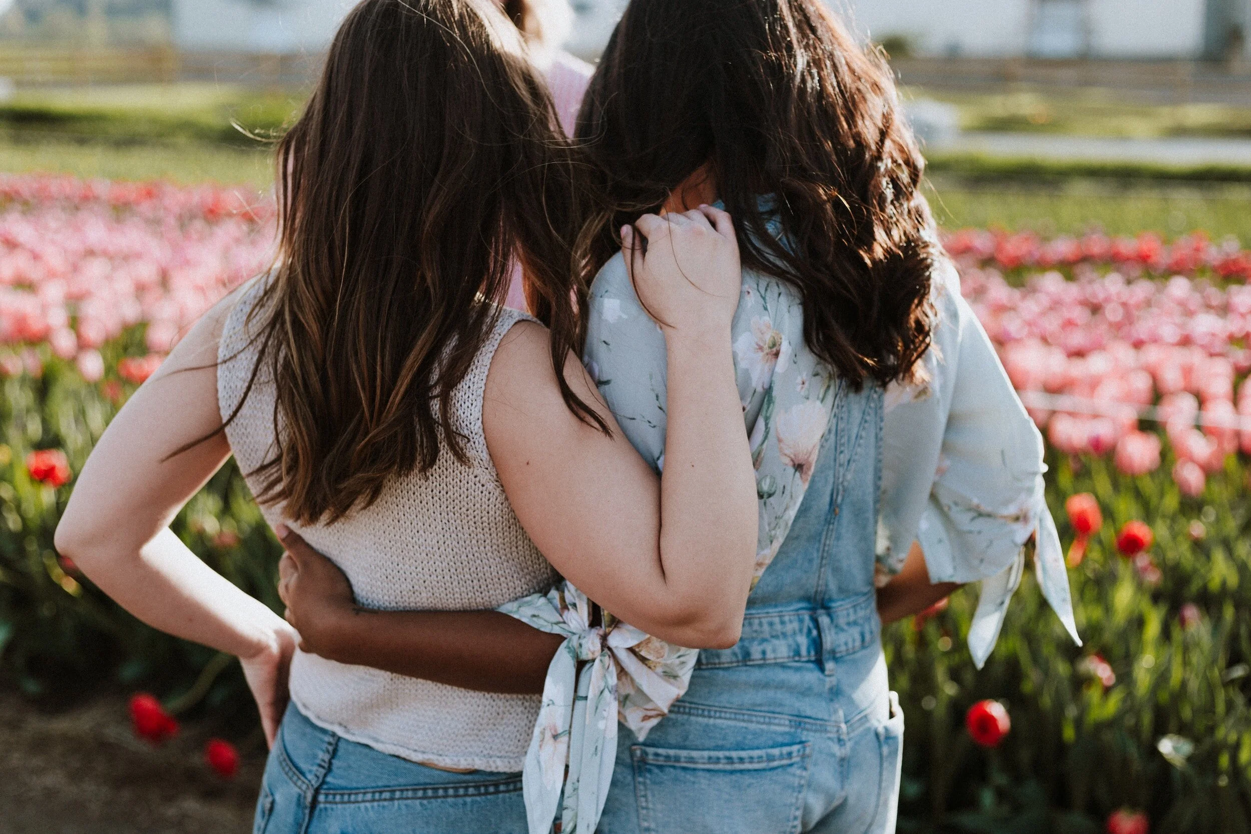 Two girls walking arm in arm